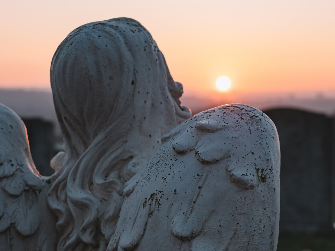 angelic statue and sunset scenery